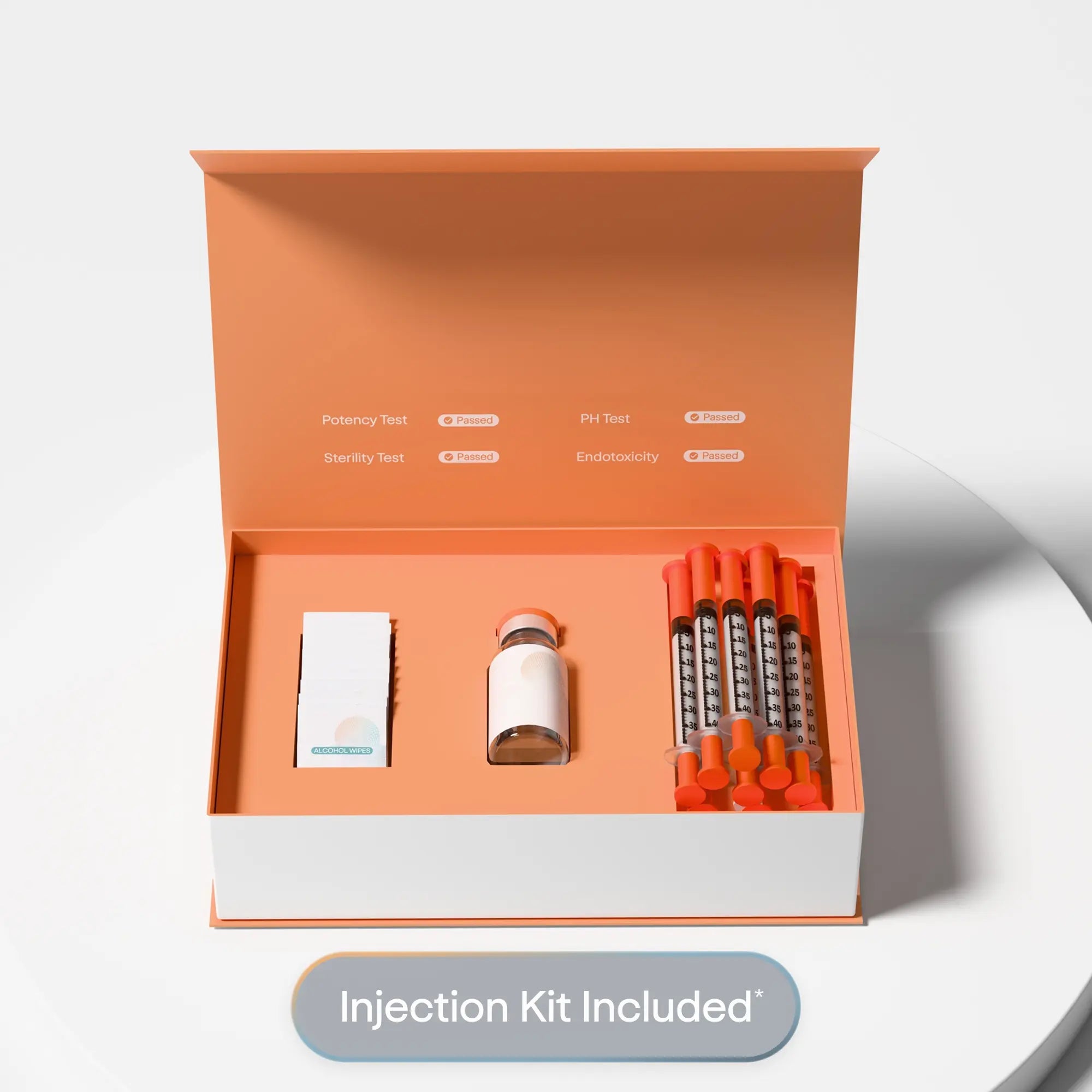 Open box containing an injection kit on a light gray background